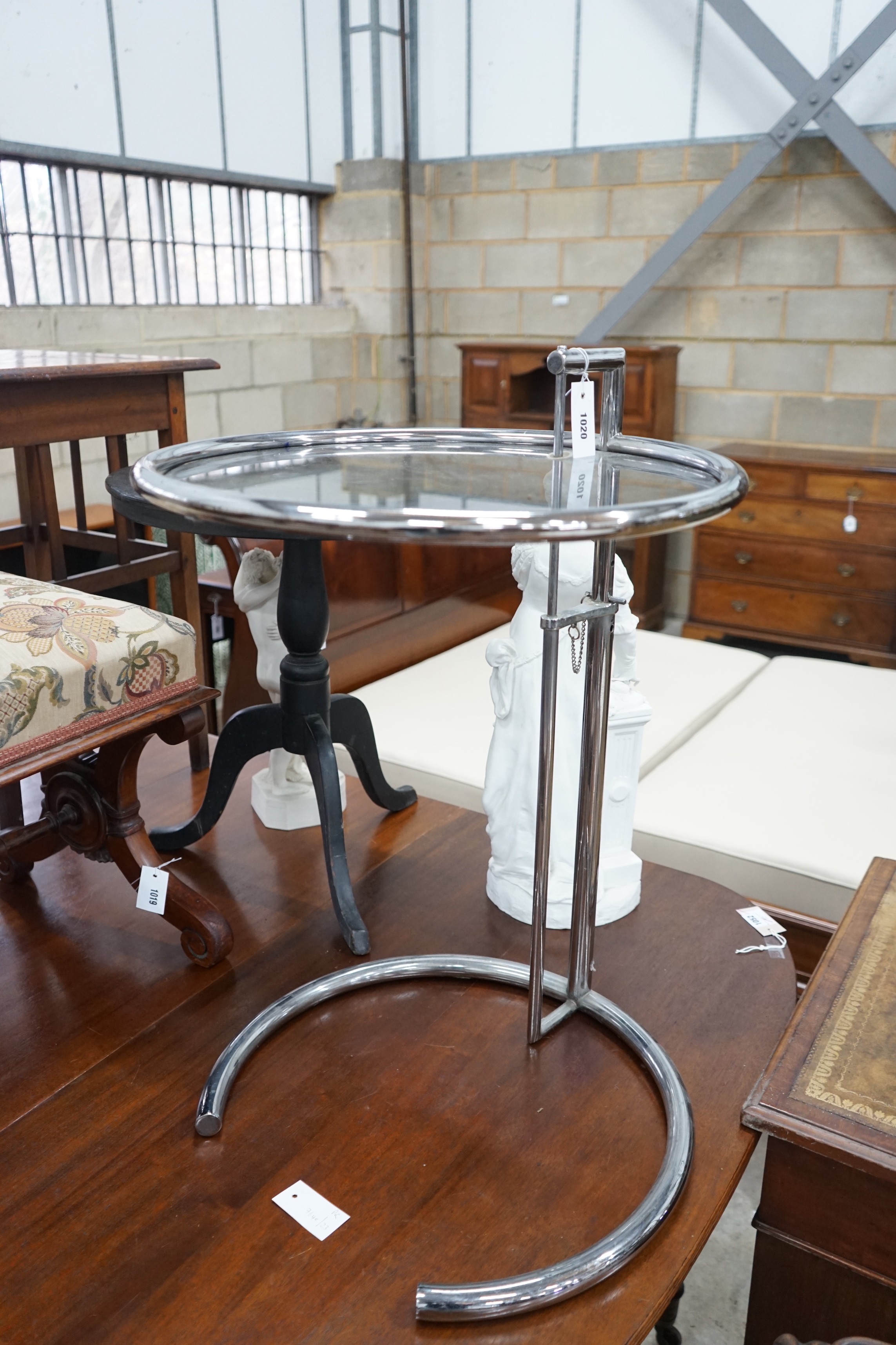 In the style of Eileen Gray - An E 1027 style circular chrome and smoked glass telescopic occasional table, diameter 51cm